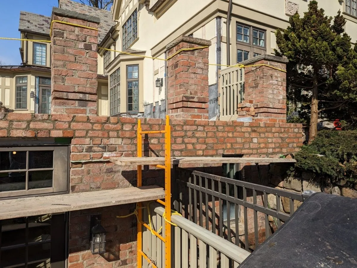 Brick Masonry restoration professionals working on large commercial brick building facade in New Jersey